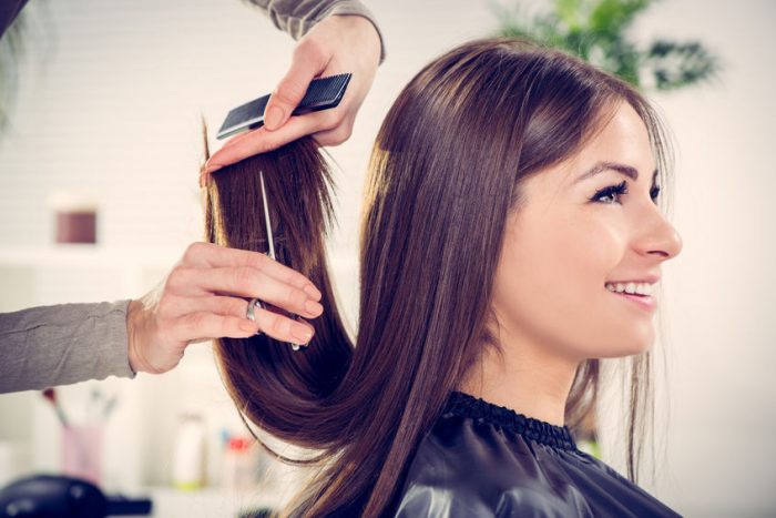 young beautiful woman having her hair cut at the hairdresser's.